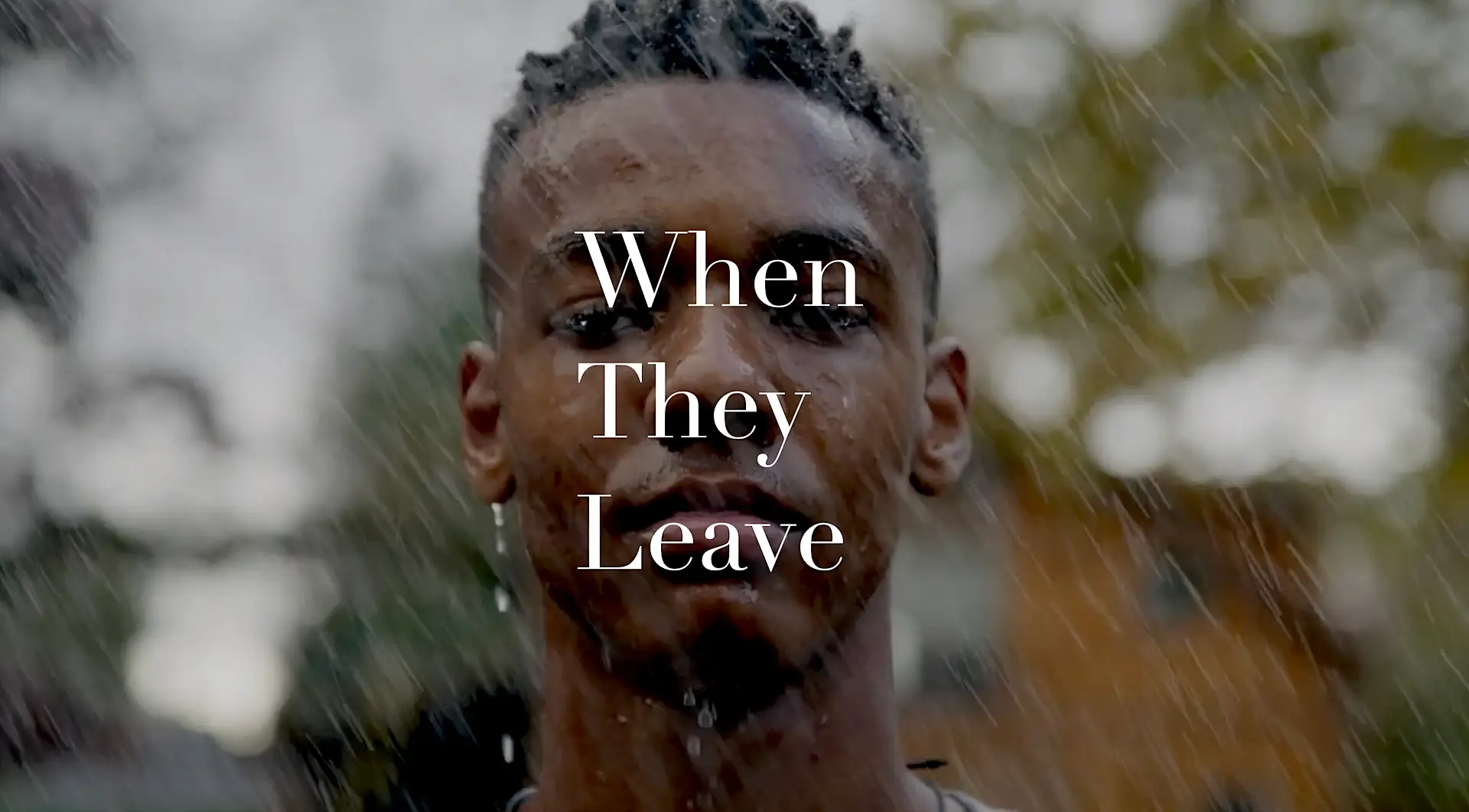 Portrait of a young man with water droplets on his face, text overlay reads 'When They Leave'. Portrait of a young man with water droplets on his face, text overlay reads 'When They Leave'.