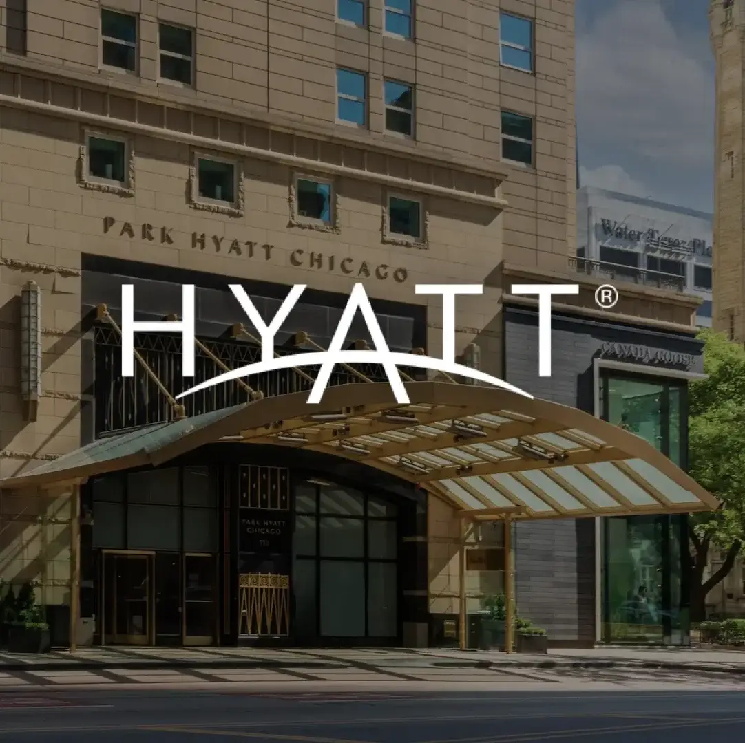 Entrance of the Park Hyatt Chicago featuring a glass canopy and the Hyatt logo.