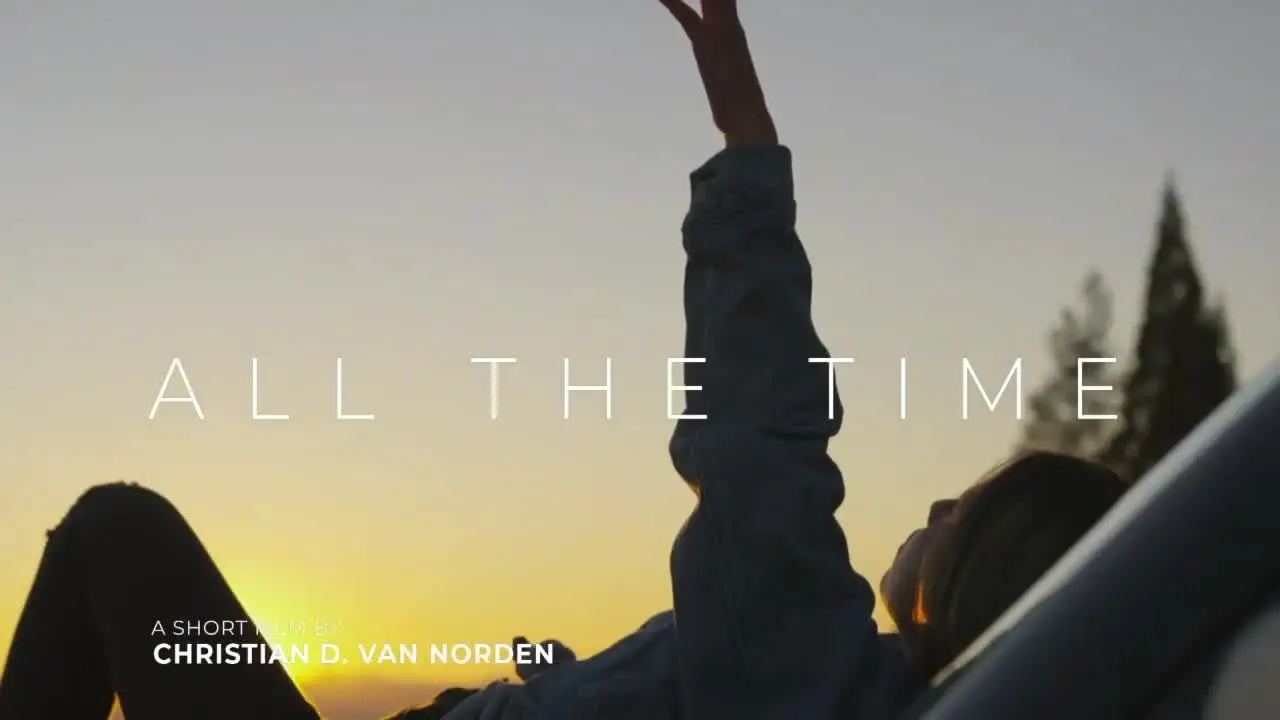 Title screen of the short film 'All the Time' with a person reaching towards the sky at sunset.